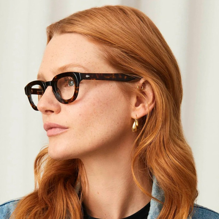 Model wears Moscot Telena black tortoise